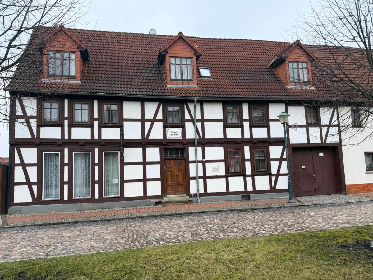 Die Fachwerkfassade der Pension mit drei Dachgauben und dem Schild Pension am Park